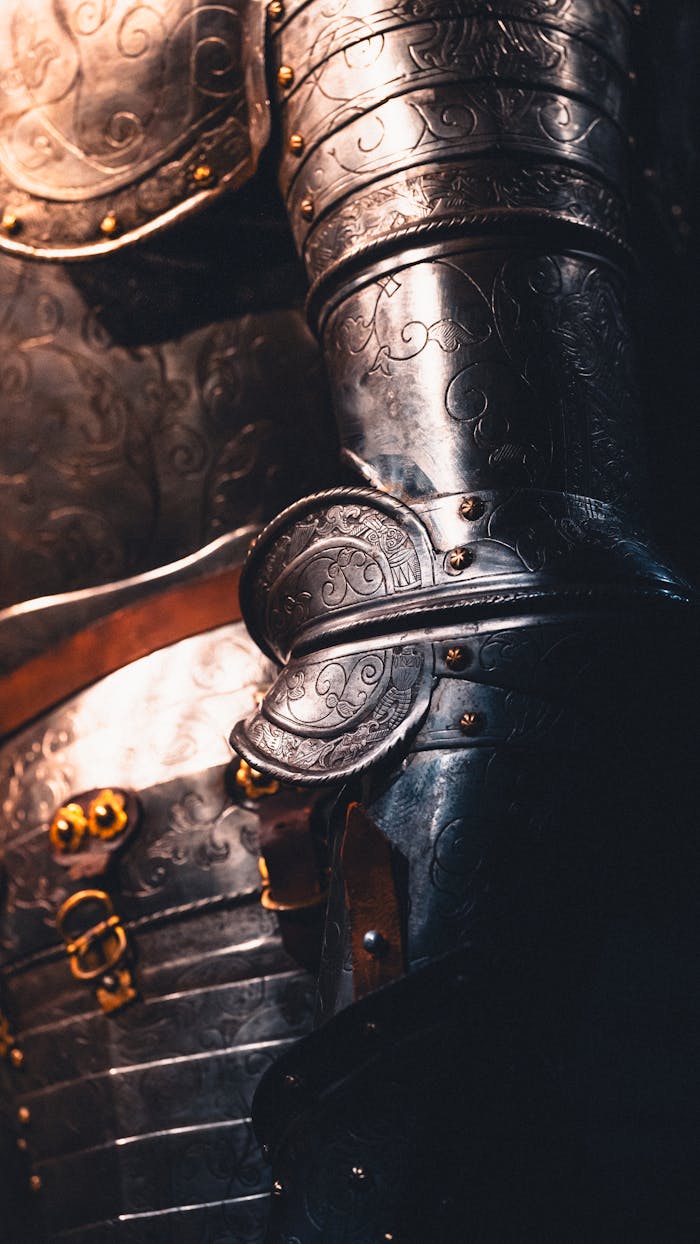 Detailed view of ornate medieval armor showcasing intricate engravings and craftsmanship.
