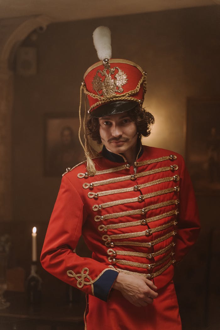 Portrait of a man dressed in a red hussar uniform, evoking a historical military setting.